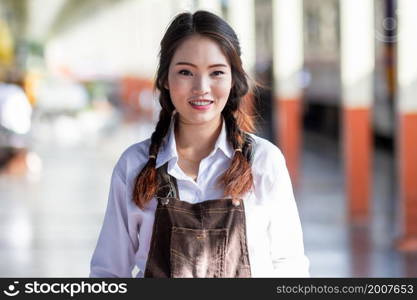 Portrait of Asian woman pregnant in at railway station travel,traveler with backpack in summer Holiday concept Thailand