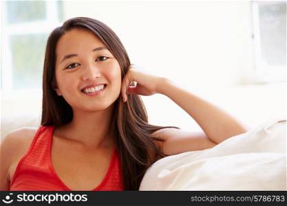 Portrait Of Asian Woman Relaxing Sitting On Sofa