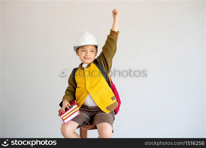 Portrait of Asian yellow coat and white engineer helmet show action of cheerful and fight for future concept on white background.