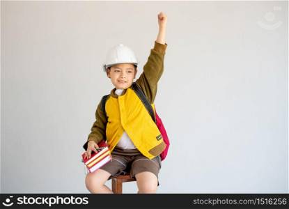 Portrait of Asian yellow coat and white engineer helmet show action of cheerful and fight for future concept on white background.