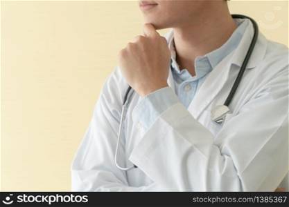 Portrait of Asian young doctor with arms crossed holding stethoscope in hospital emergency lap. Concept of healthcare patient lifestyle and medical.
