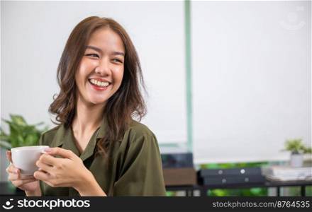 Portrait of Asian young woman holding hot coffee or tea cup in morning while posing, white porcelain mug mock up, Happy beautiful woman relaxing in summer after wakeup at home, lifestyle