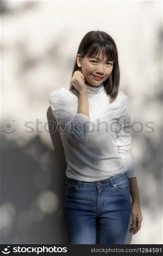 portrait of asian younger woman relaxing with smiling face standing outdoor