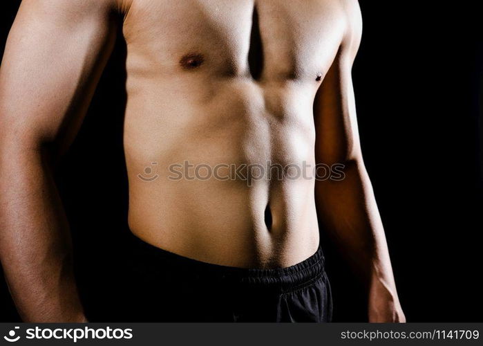 portrait of athletic muscular bodybuilder man with naked torso six pack abs. fitness workout concept