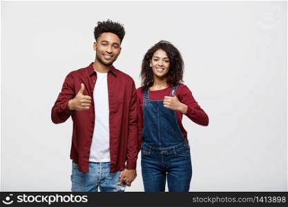 Portrait of attractive African american couple showing thumb up over white studio background. Portrait of attractive African american couple showing thumb up over white studio background.