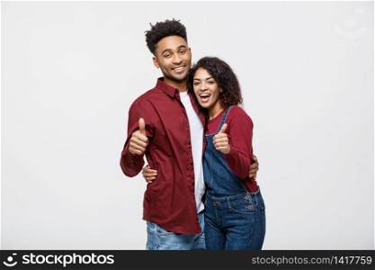 Portrait of attractive African american couple showing thumb up over white studio background. Portrait of attractive African american couple showing thumb up over white studio background.