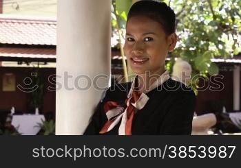 Portrait of attractive Asian girl at work as waitress in luxury restaurant. Close-up