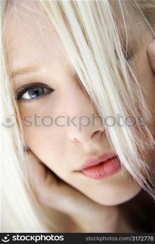 Portrait of attractive blonde Caucasian young adult woman looking at viewer.