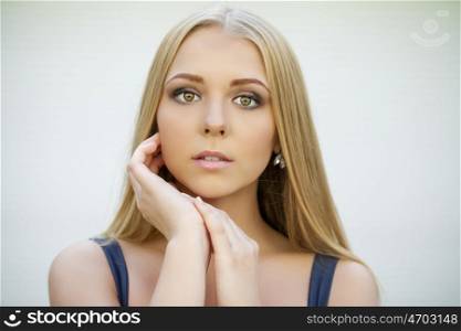 Portrait of attractive blonde girl, makeup female face indoor
