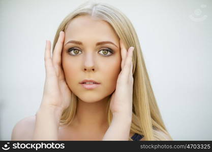 Portrait of attractive blonde girl, makeup female face indoor