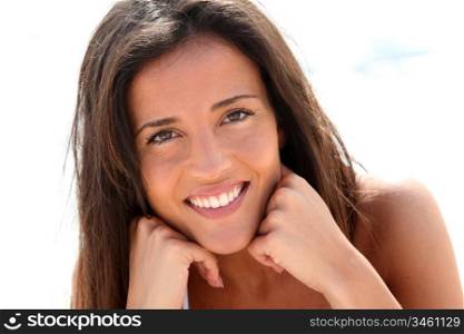 Portrait of attractive brunette laying on a beach
