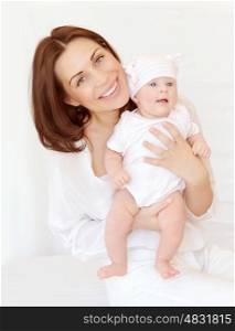 Portrait of attractive brunette mother carry cute baby girl in hands, at home, happy motherhood, young family, love concept