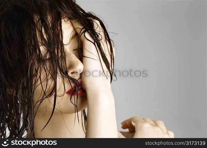 Portrait of attractive Caucasian redhead young woman with wet hair.