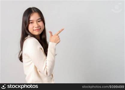 Portrait of attractive cheerful girl demonstrating and pointing finger to the side empty space isolated white background, showing advertisement, standing against. Advertisement & presentation concept