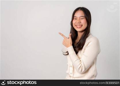 Portrait of attractive cheerful girl demonstrating and pointing finger to the side empty space isolated white background, showing advertisement, standing against. Advertisement   presentation concept