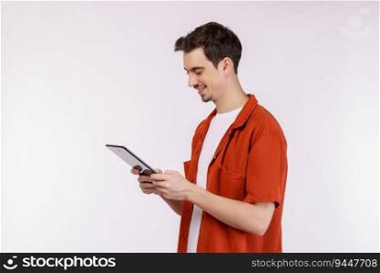Portrait of attractive cheerful man using device app searching web isolated over white color background. Technology and business concept.