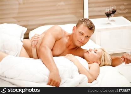 Portrait of attractive couple in bedroom