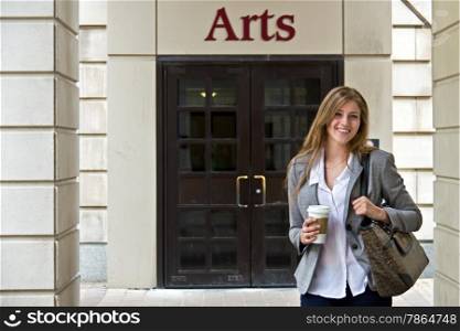 Portrait of attractive female student outside campus building