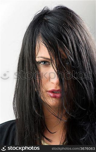 Portrait of attractive female with black hair on her face