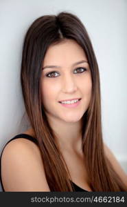 Portrait of attractive girl with brown eyes against the wall