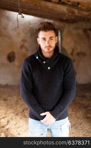 Portrait of attractive guy in a old house