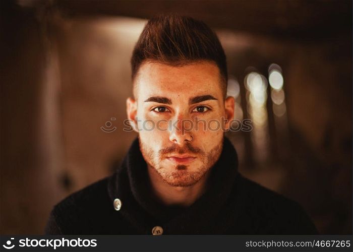 Portrait of attractive guy in a old house. Photos for ads