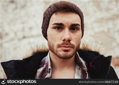 Portrait of attractive guy with wool hat in a old house. Photos for ads