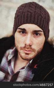 Portrait of attractive guy with wool hat in a old house. Photos for ads