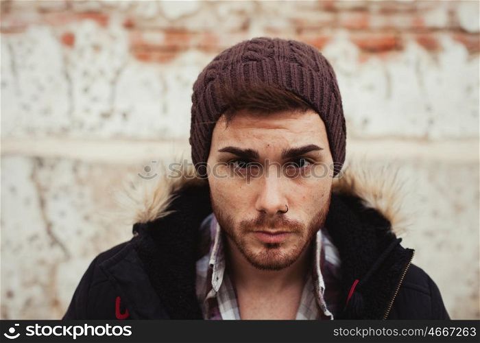 Portrait of attractive guy with wool hat in a old house. Photos for ads