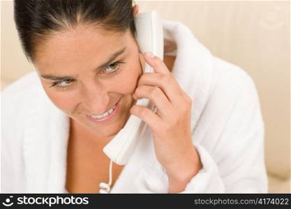 Portrait of attractive mid-aged woman speaking on phone wear bathrobe