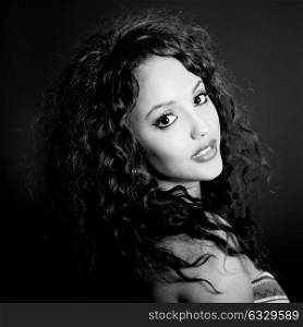 Portrait of attractive mixed woman on black background