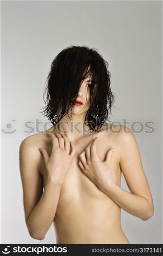 Portrait of attractive nude Caucasian young woman redhead with wet hair.