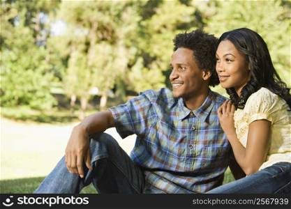 Portrait of attractive smiling couple in park.