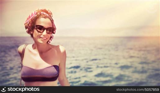 Portrait of attractive smiling girl relaxing on the beach, beautiful mild sunset light, luxury lifestyle, summer holidays concept