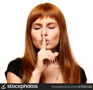 portrait of attractive teenage girl with finger on lips