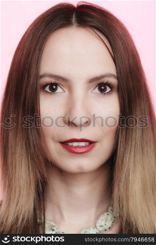 Portrait of attractive woman in necklace on pink. Face of beautiful girl with professional makeup red lipstick on lips.