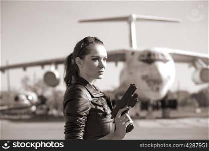 portrait of attractive woman near plane. sepia