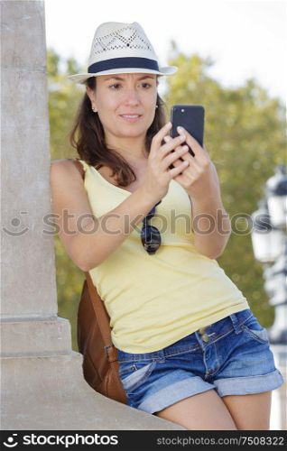 portrait of attractive woman sending photos to friend