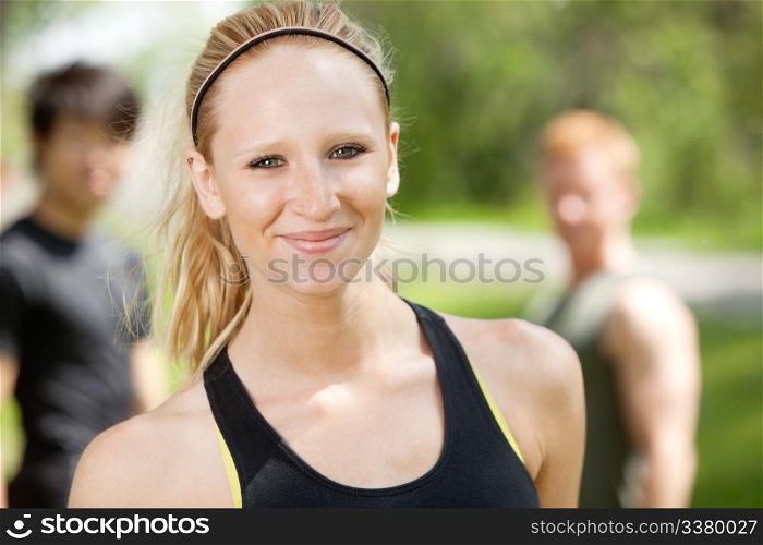 Portrait of attractive woman with friends in background