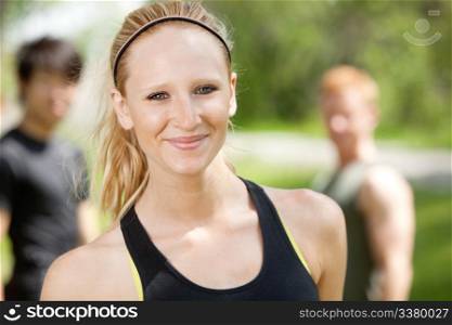 Portrait of attractive woman with friends in background