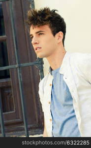 Portrait of attractive young man in urban background