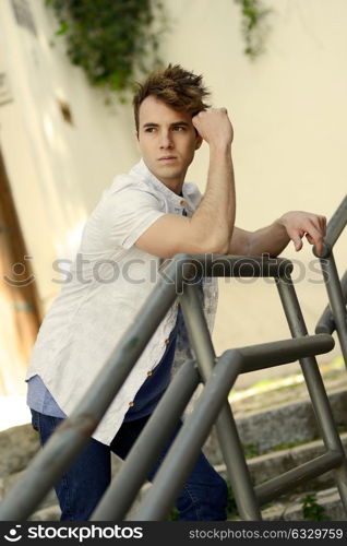 Portrait of attractive young man in urban background