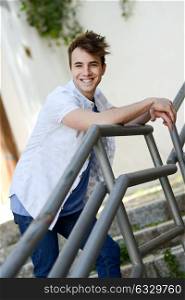 Portrait of attractive young man smiling in urban background