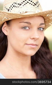 portrait of attractive young woman wearing straw hat