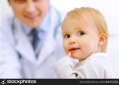 Portrait of baby and pediatrician doctor in background&#xA;