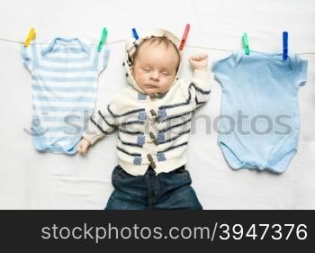 Portrait of baby boy drying on clothesline after laundry