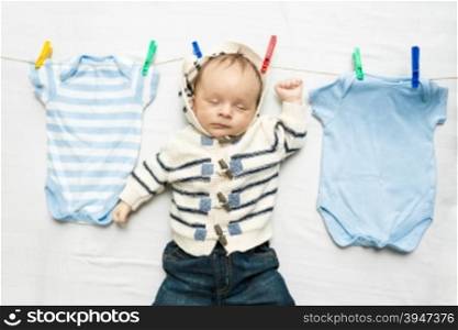 Portrait of baby boy drying on clothesline after laundry