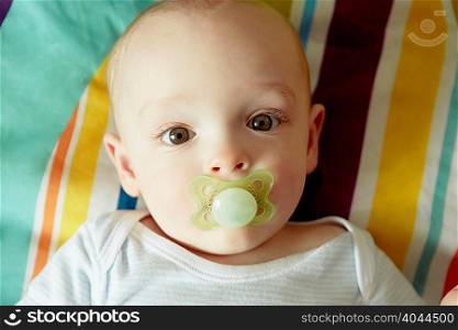 Portrait of baby boy sucking pacifier