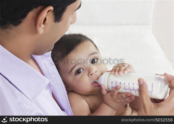 Portrait of baby drinking milk