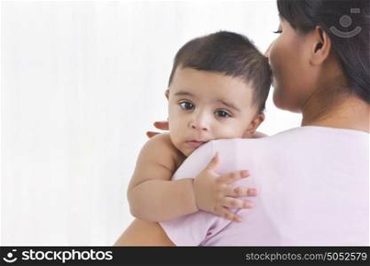Portrait of baby in mothers arms
